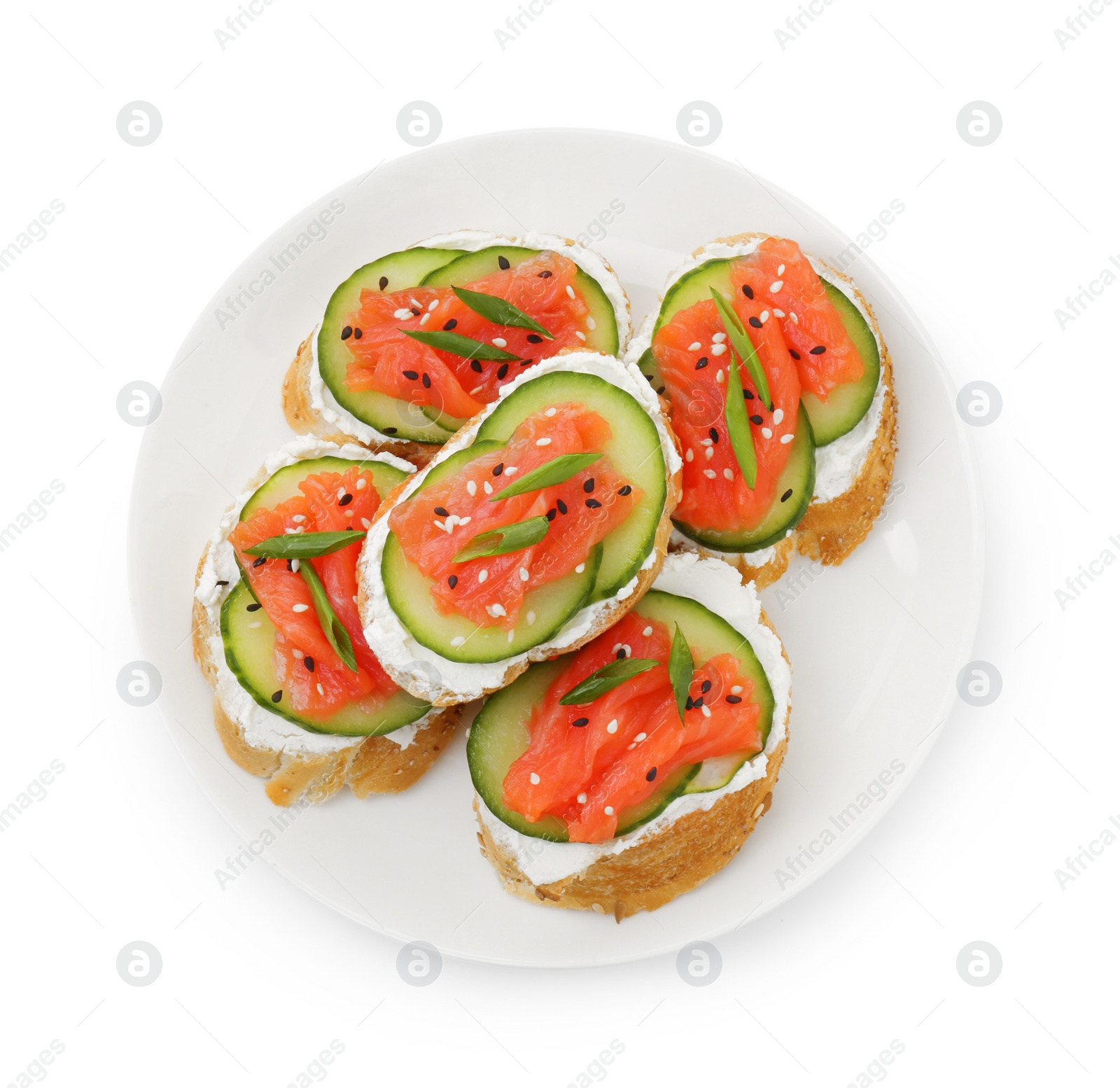 Photo of Tasty canapes with salmon, cucumber and cream cheese isolated on white, top view