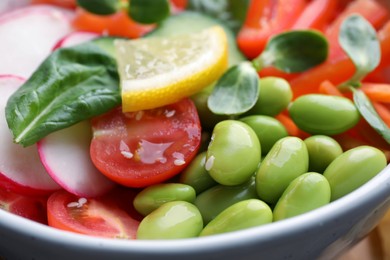 Closeup view of poke bowl with salmon, edamame beans and vegetables