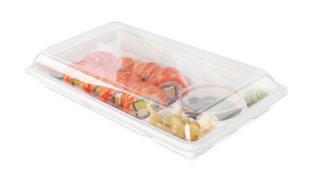 Photo of Food delivery. Delicious sushi rolls with soy sauce, ginger, wasabi and chopsticks in plastic container isolated on white