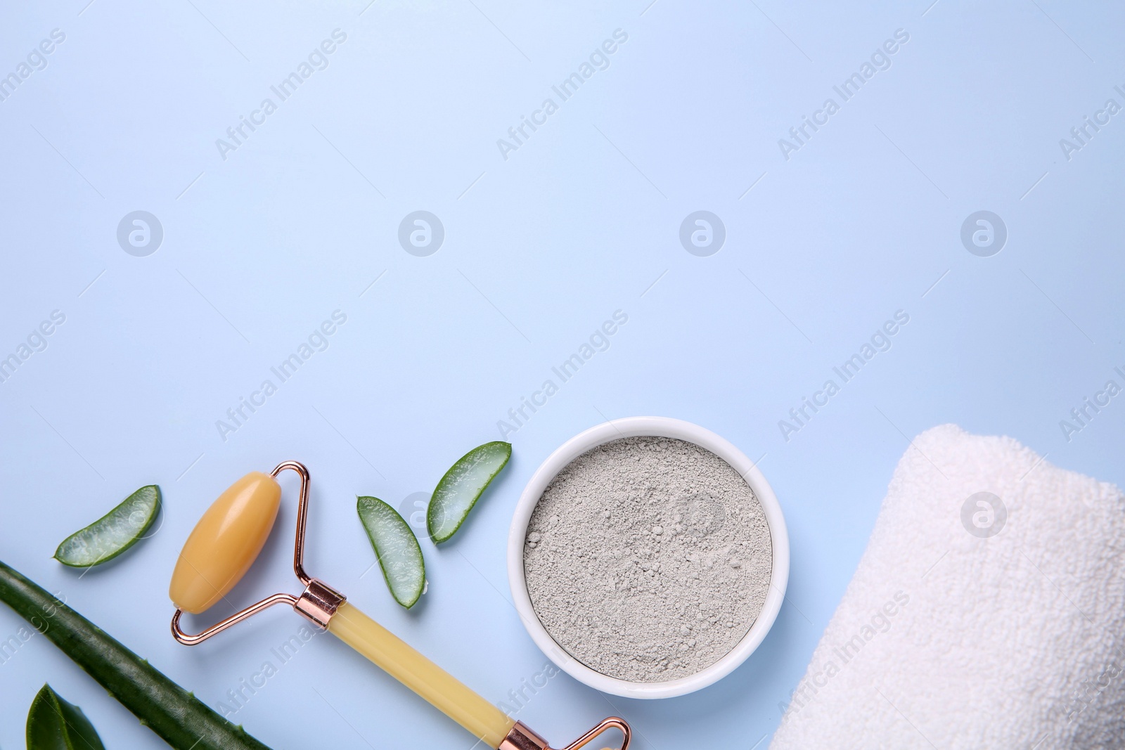 Photo of Flat lay composition with cosmetic products and cut aloe leaves on light blue background. Space for text