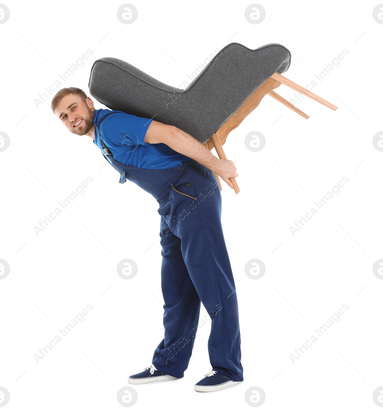 Photo of Young worker carrying armchair isolated on white. Moving service