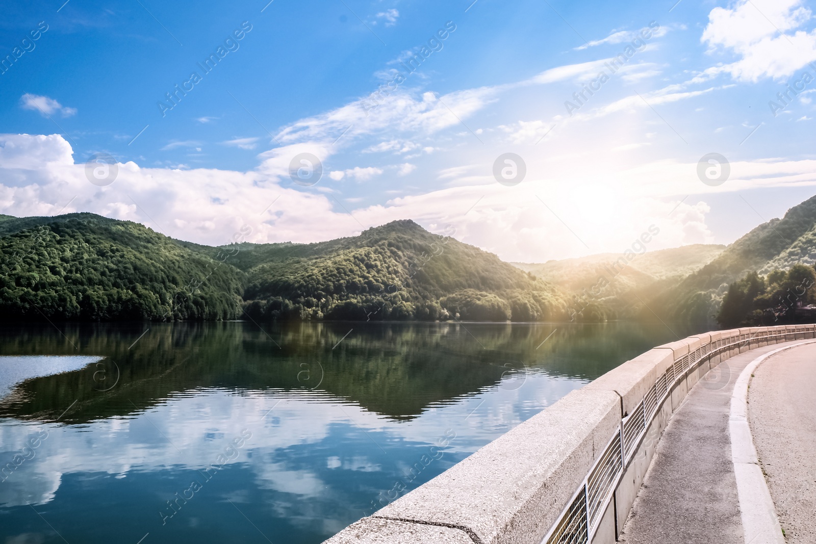 Photo of Beautiful view of road along lake on sunny day