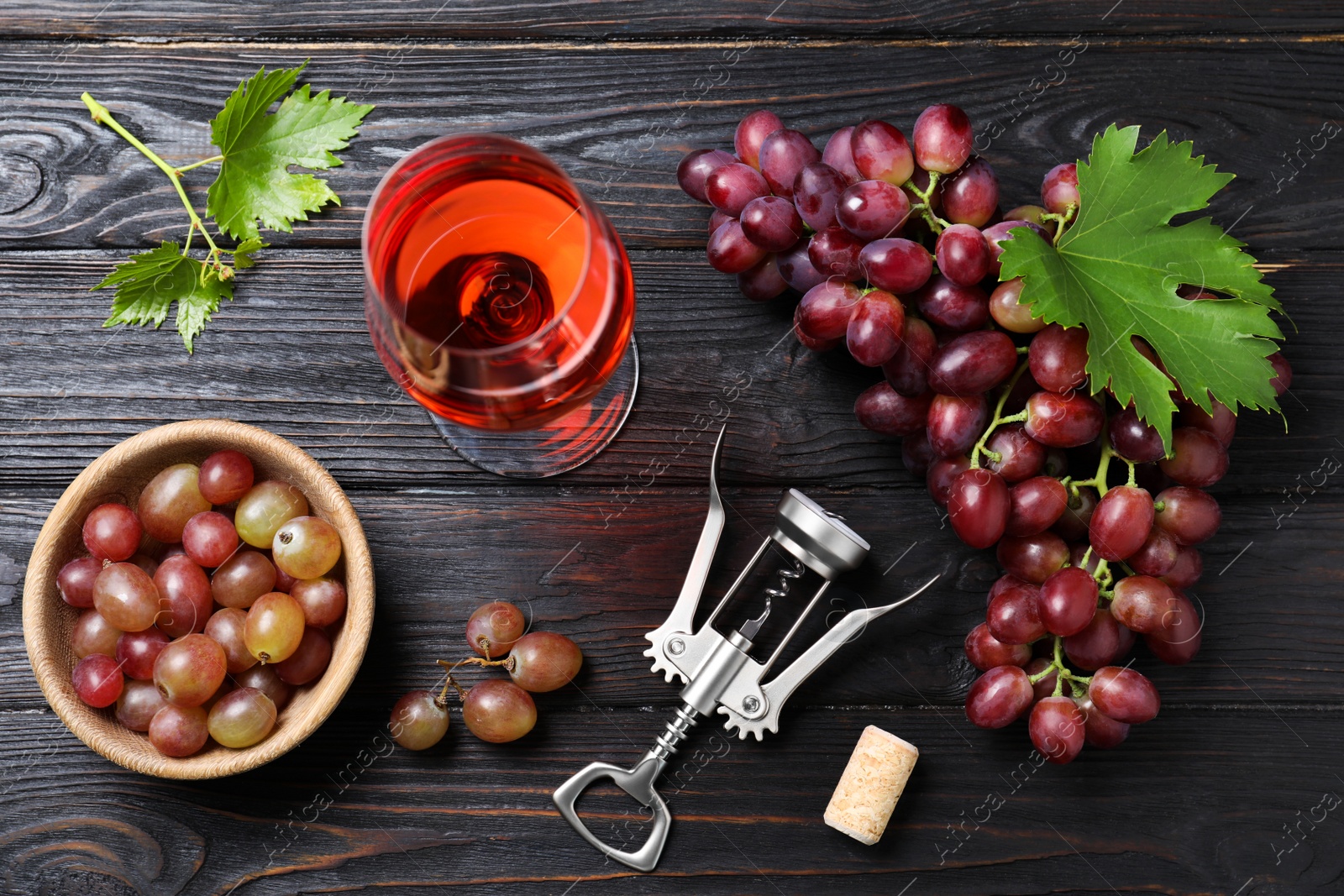 Photo of Flat lay composition with fresh ripe juicy grapes and wine on dark wooden table