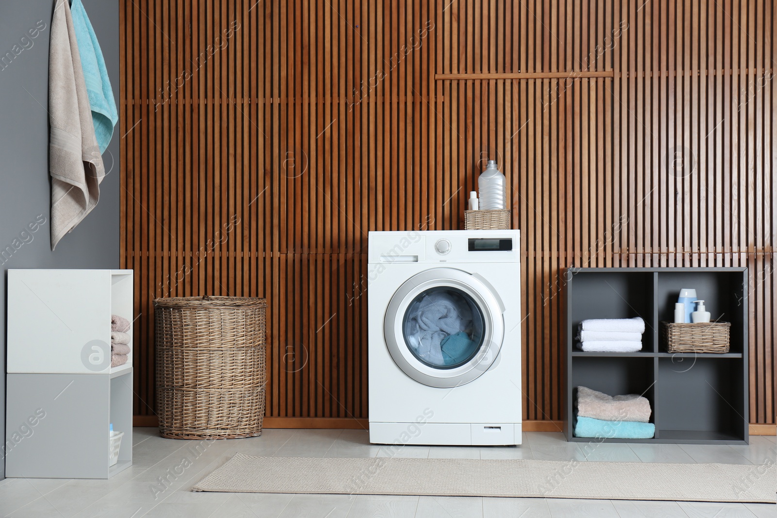 Photo of Washing of different towels in modern laundry room