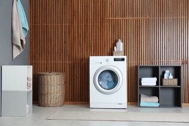 Washing of different towels in modern laundry room