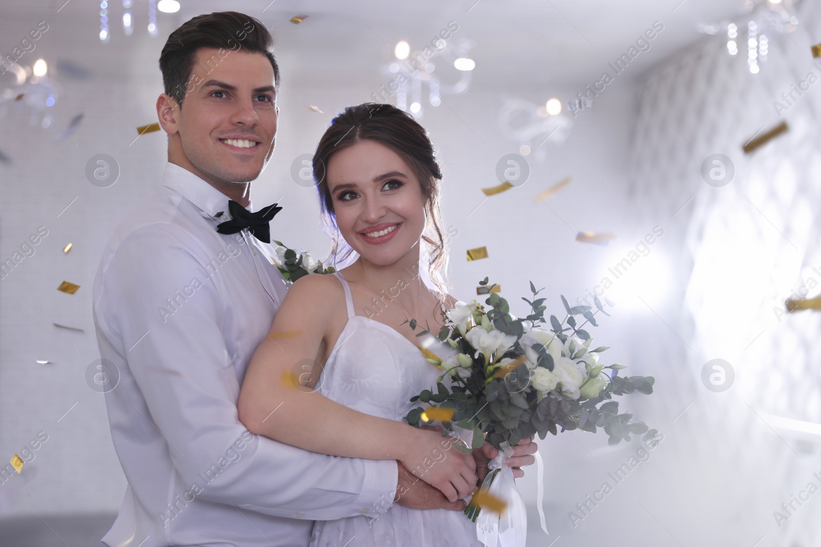 Photo of Happy newlywed couple together in festive hall