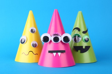 Spooky paper monsters on light blue background. Halloween decoration