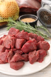 Pieces of beef on white wooden table, closeup