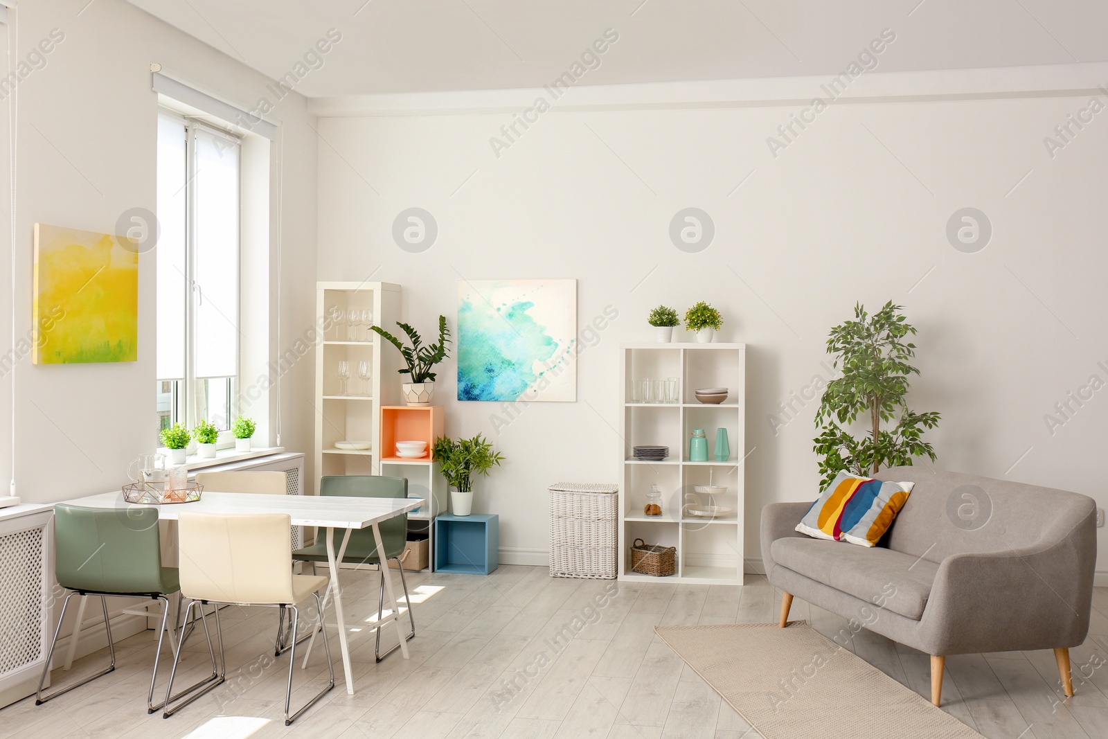 Photo of Stylish apartment interior with dining table and sofa