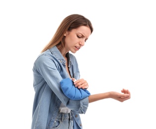 Photo of Woman applying cold compress to relieve arm pain on white background