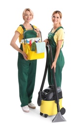 Female janitors with cleaning equipment on white background