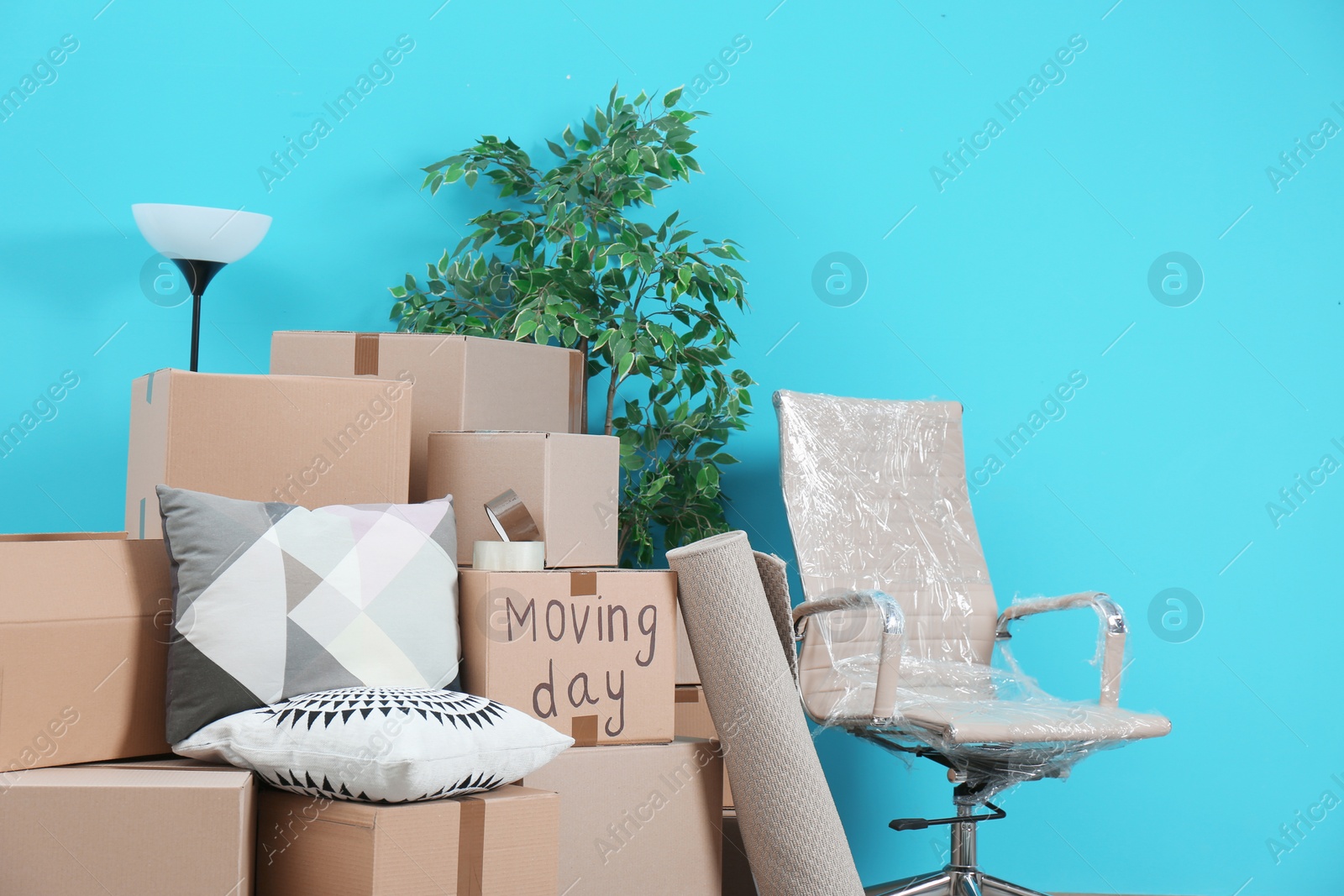 Photo of Cardboard boxes and household stuff in empty room. Moving day