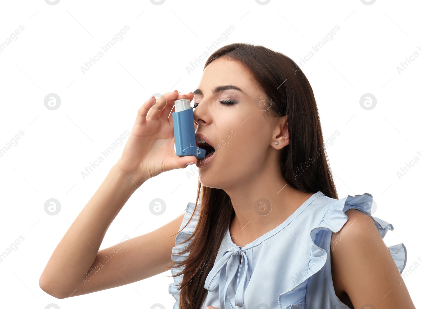 Photo of Young woman using asthma inhaler on white background