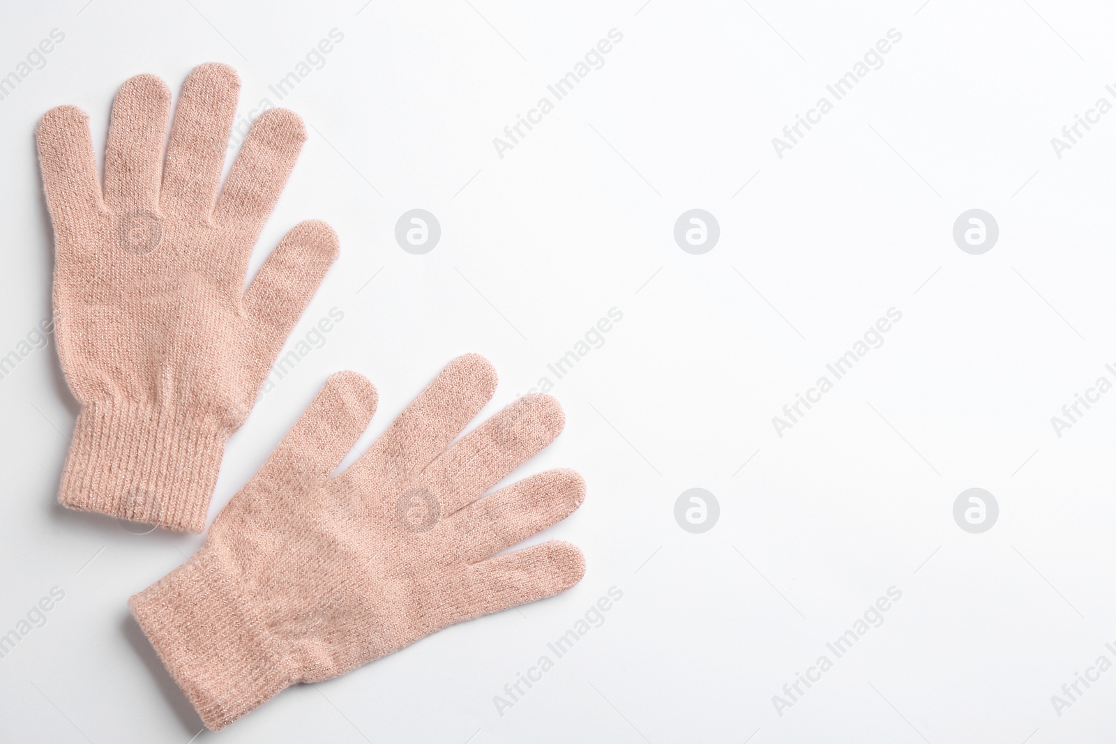 Photo of Pair of stylish woolen gloves on white background, flat lay. Space for text