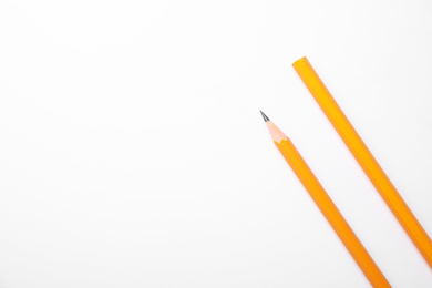 Pencil with point and unsharpened one on background white, top view. Space for text