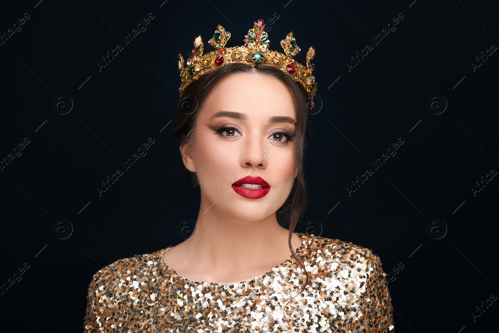 Photo of Beautiful young woman wearing luxurious crown on black background