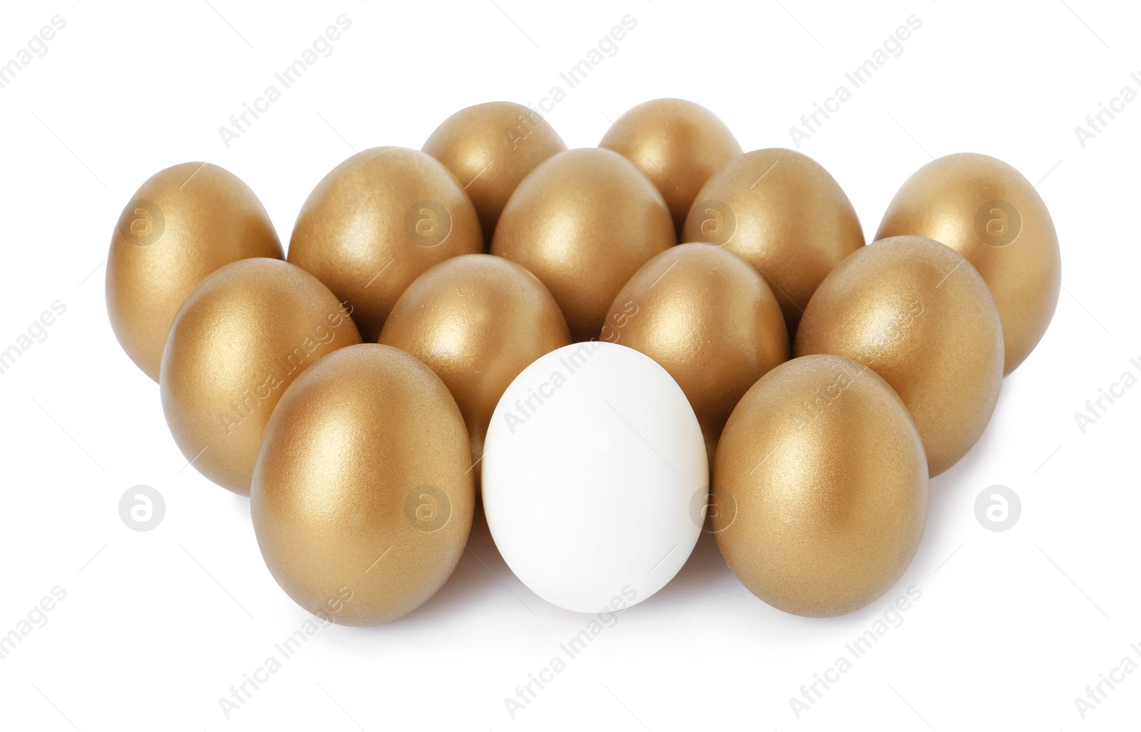 Photo of Golden eggs with different one on white background