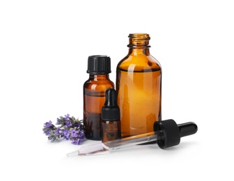 Photo of Bottles with natural lavender oil, flowers and dropper on white background