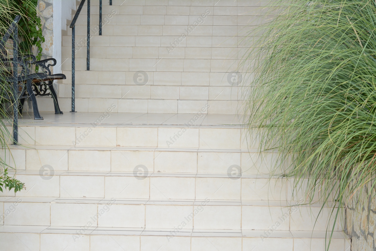 Photo of View of stone outdoor staircase decorated with plants