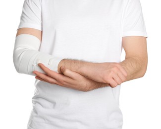 Man with arm wrapped in medical bandage on white background, closeup