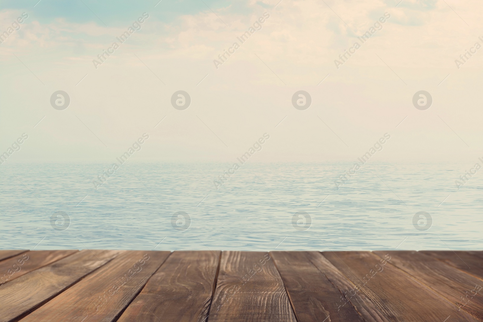Image of Empty wooden table near sea. Summer season