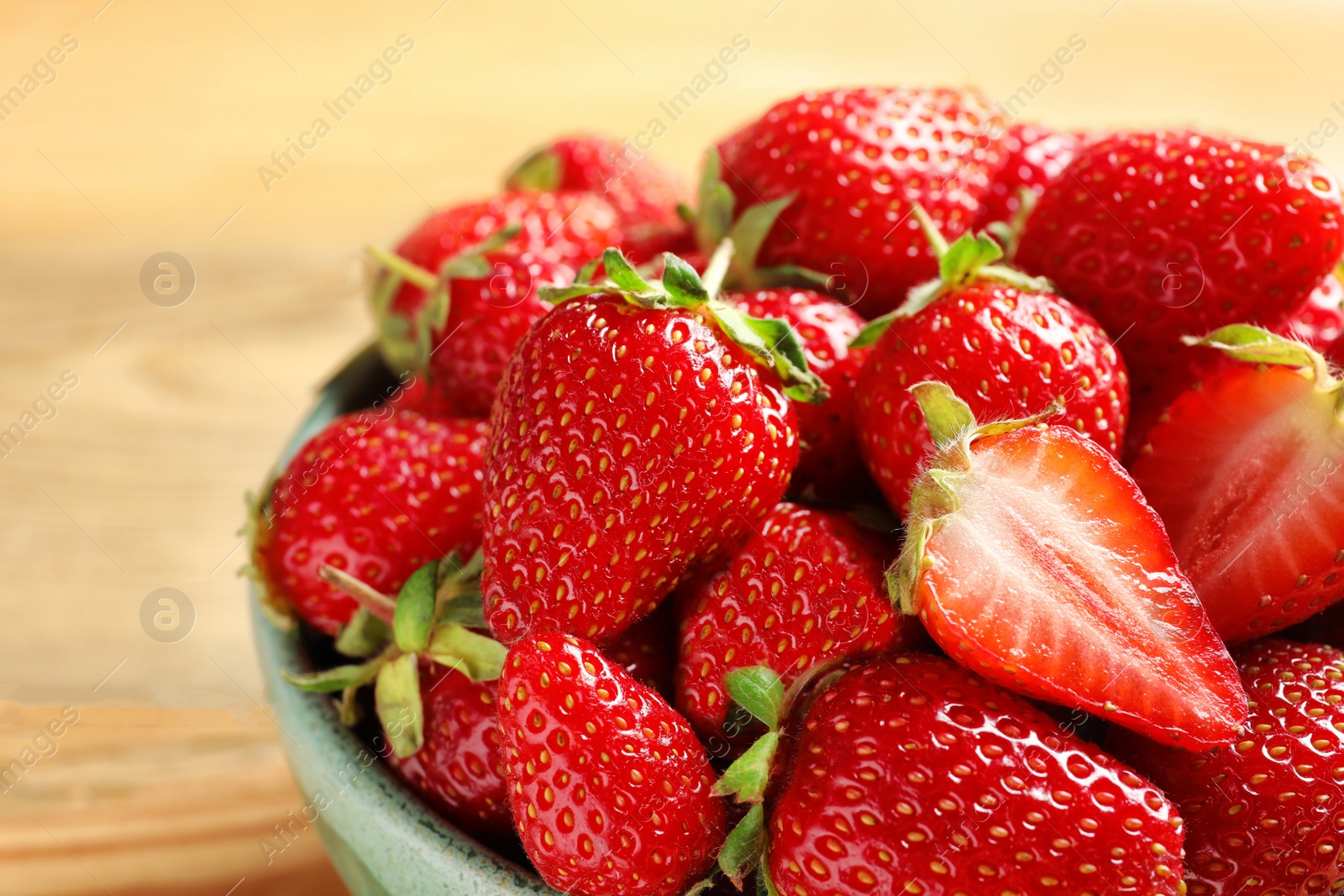 Photo of Bowl with fresh ripe strawberries on table, closeup