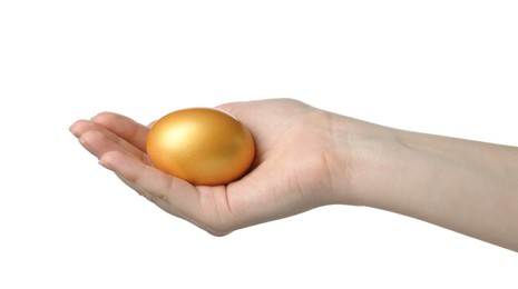 Woman holding golden egg on white background, closeup
