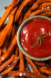 Plate with delicious sweet potato fries and sauce, closeup