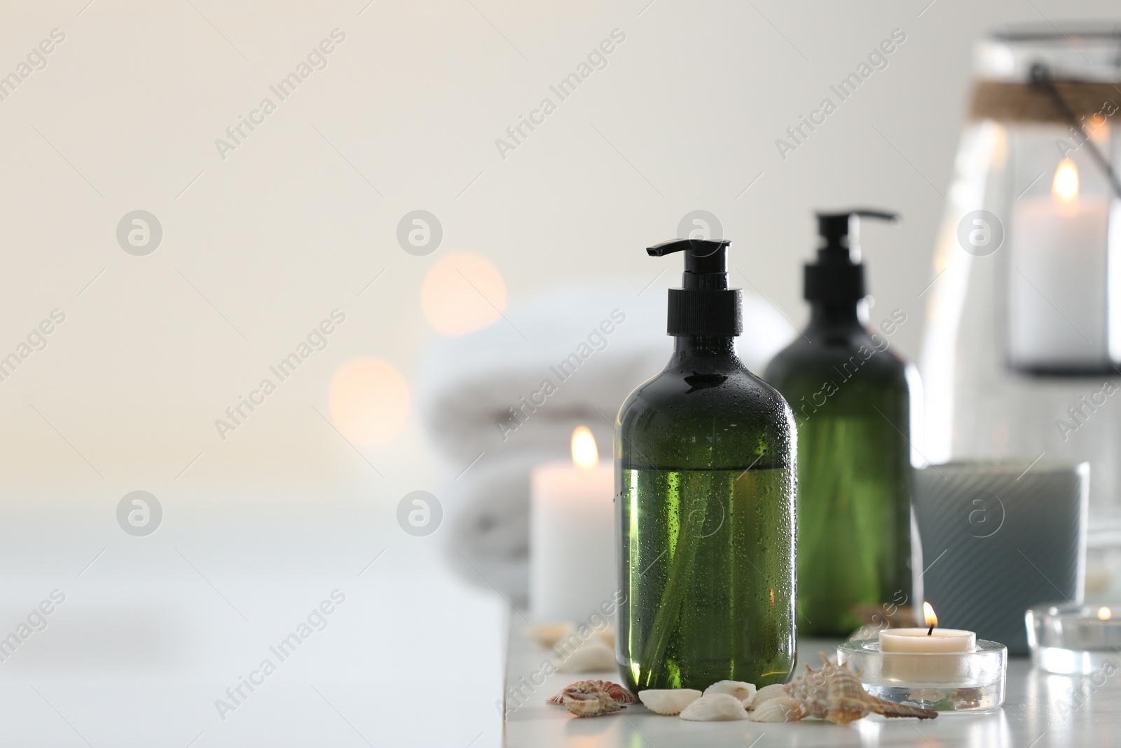 Photo of Soap dispensers and decor elements on table. Space for text