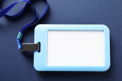 Photo of Blank badge with string on blue background, top view