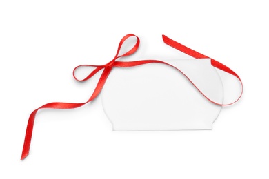 Photo of Blank gift tag with satin ribbon on white background, top view