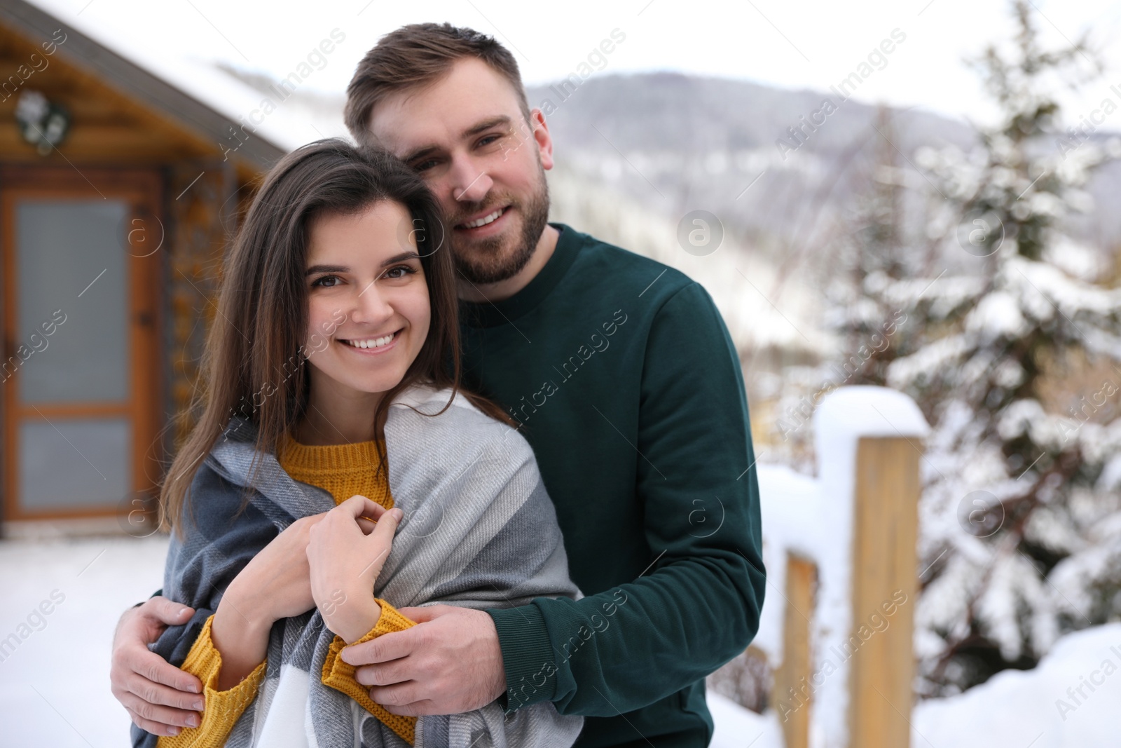 Photo of Lovely couple walking together on snowy day. Winter vacation