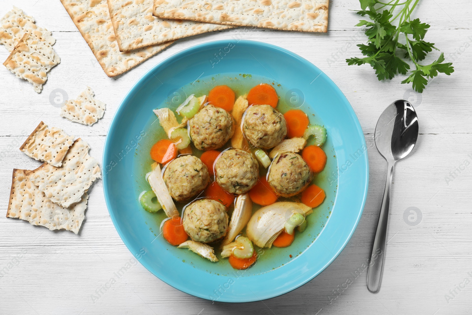 Photo of Flat lay composition with Jewish matzoh balls soup on white wooden table