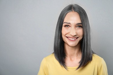 Image of Portrait of senior woman on light grey background