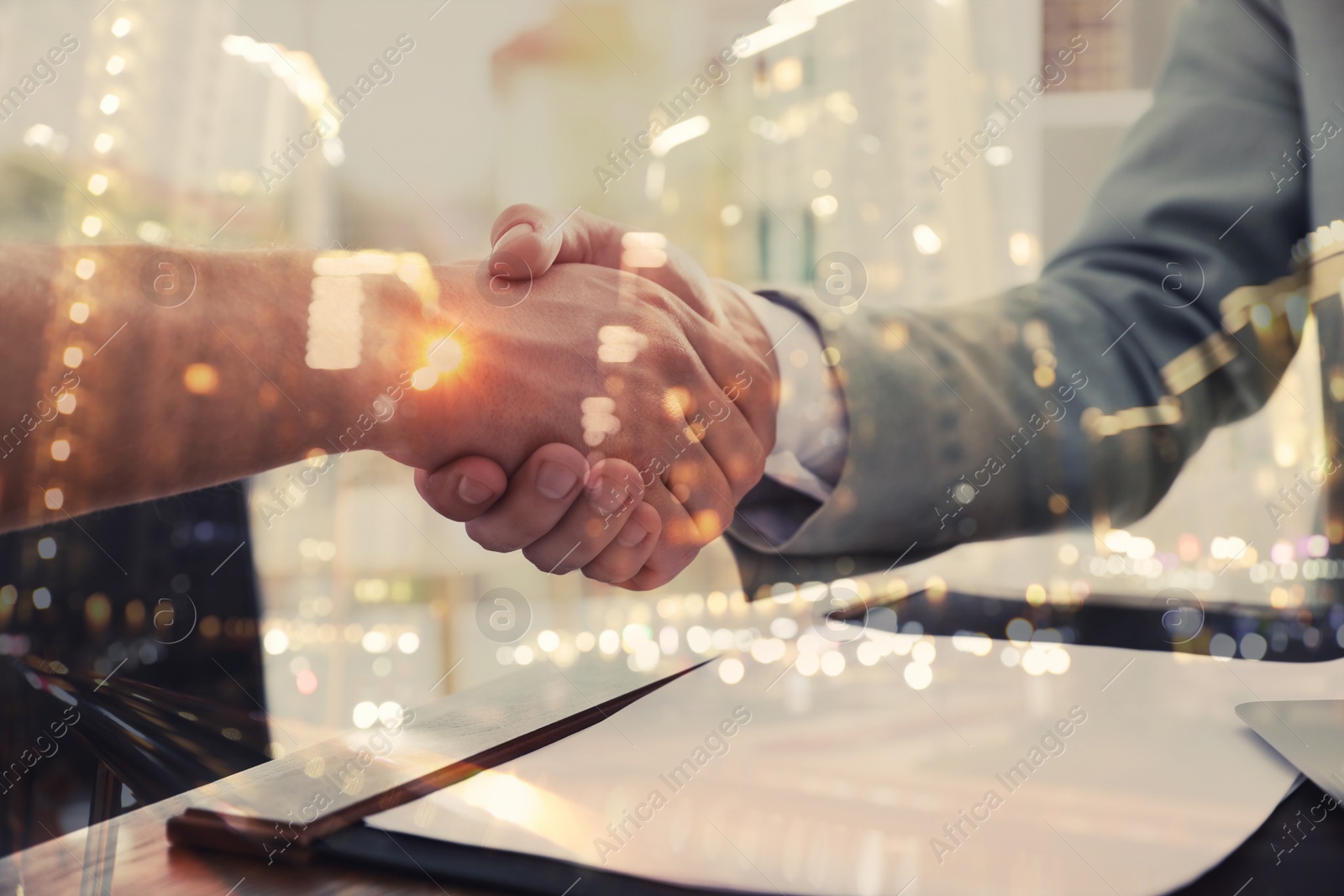 Image of Double exposure of partners shaking hands and night cityscape, closeup. Business corporation 