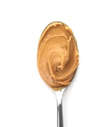 Photo of Creamy peanut butter in spoon on white background