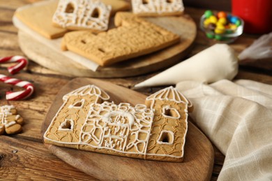 Parts of gingerbread house on wooden table, closeup