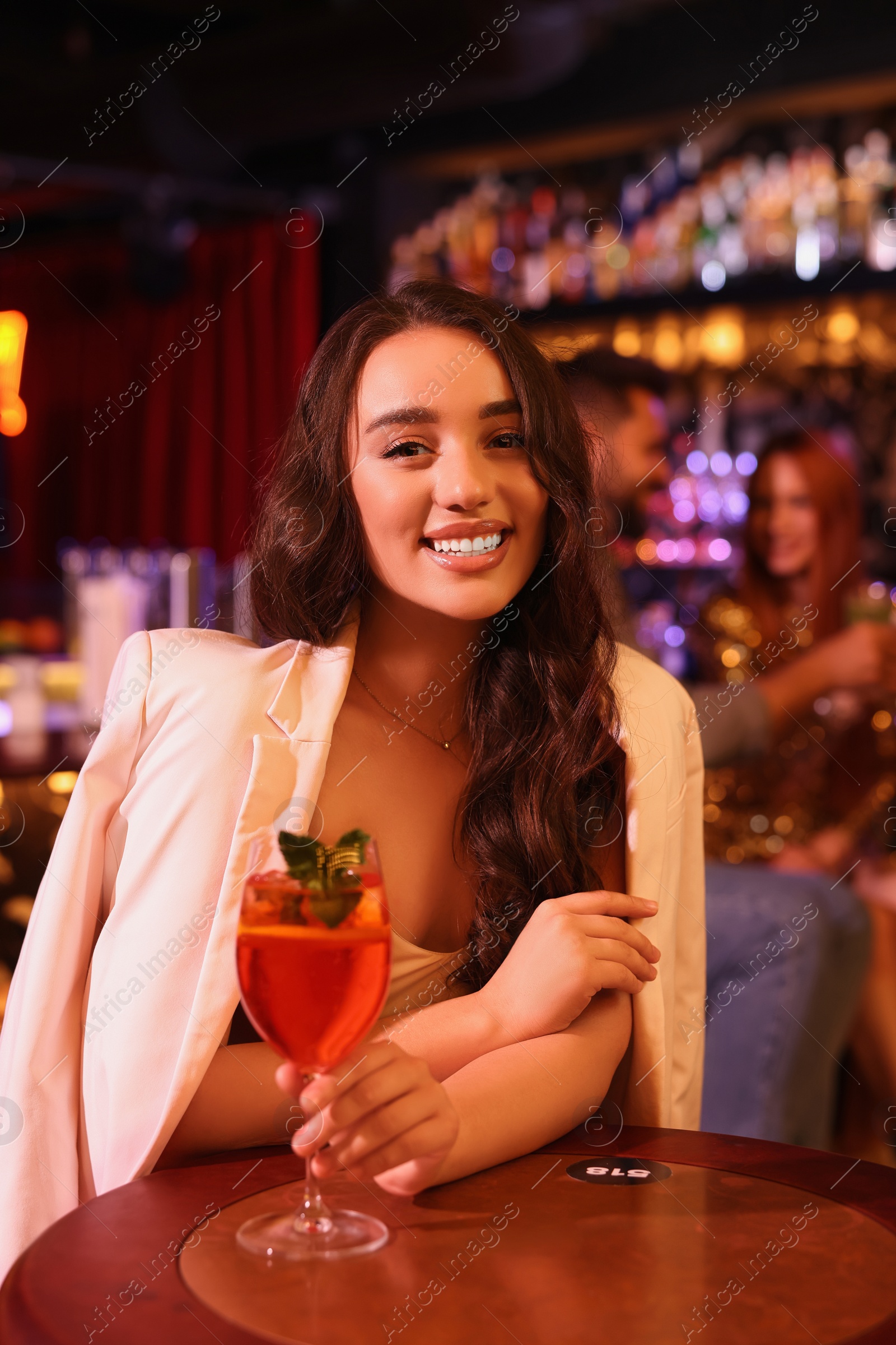 Photo of Beautiful woman with fresh alcoholic cocktail in bar