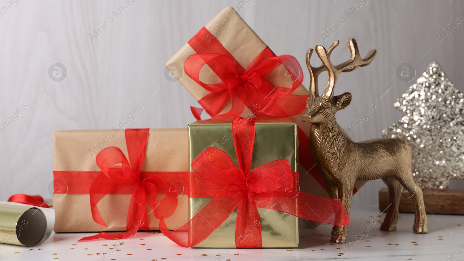 Photo of Beautifully wrapped gift boxes on white table