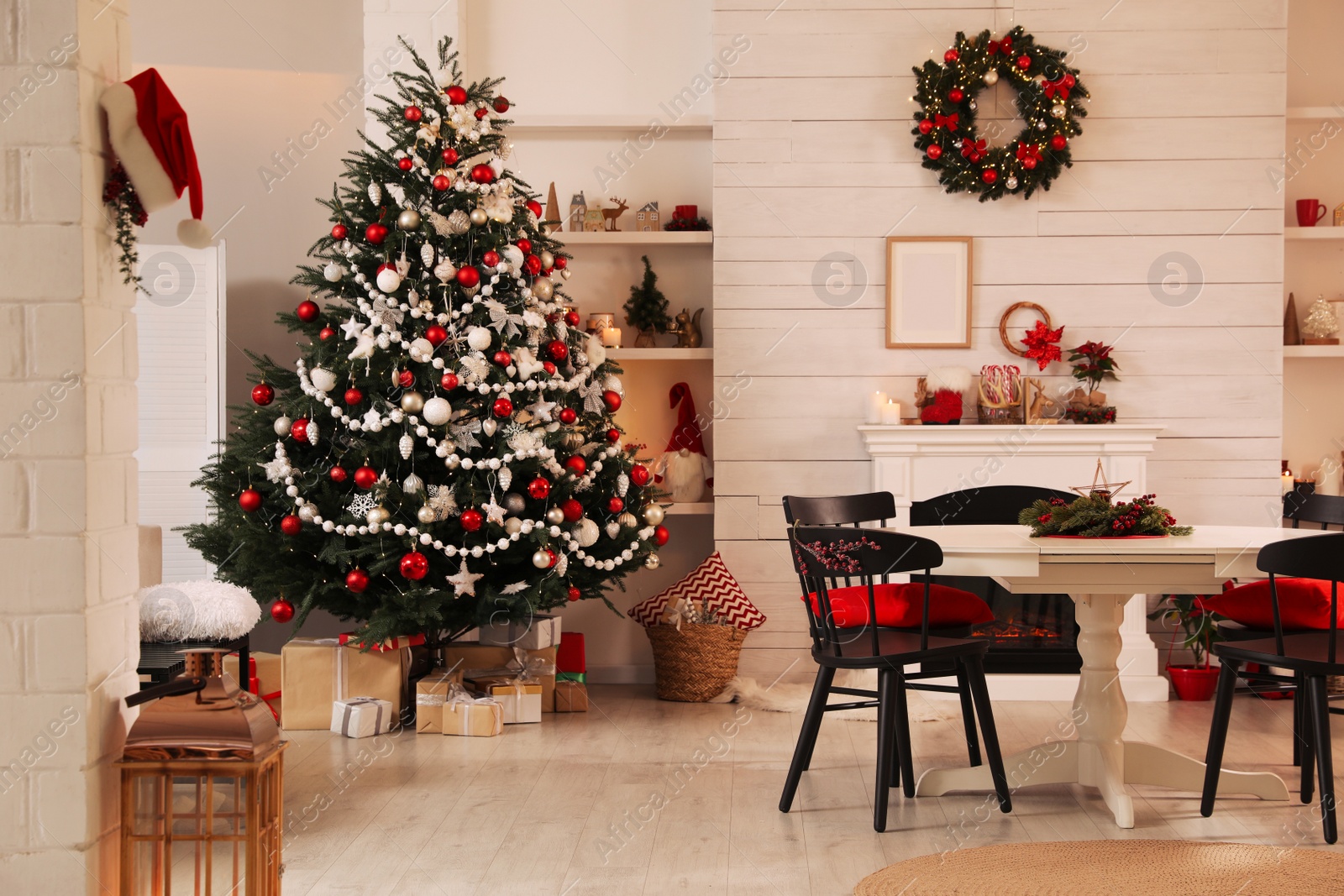 Photo of Cozy dining room interior with Christmas tree and festive decor