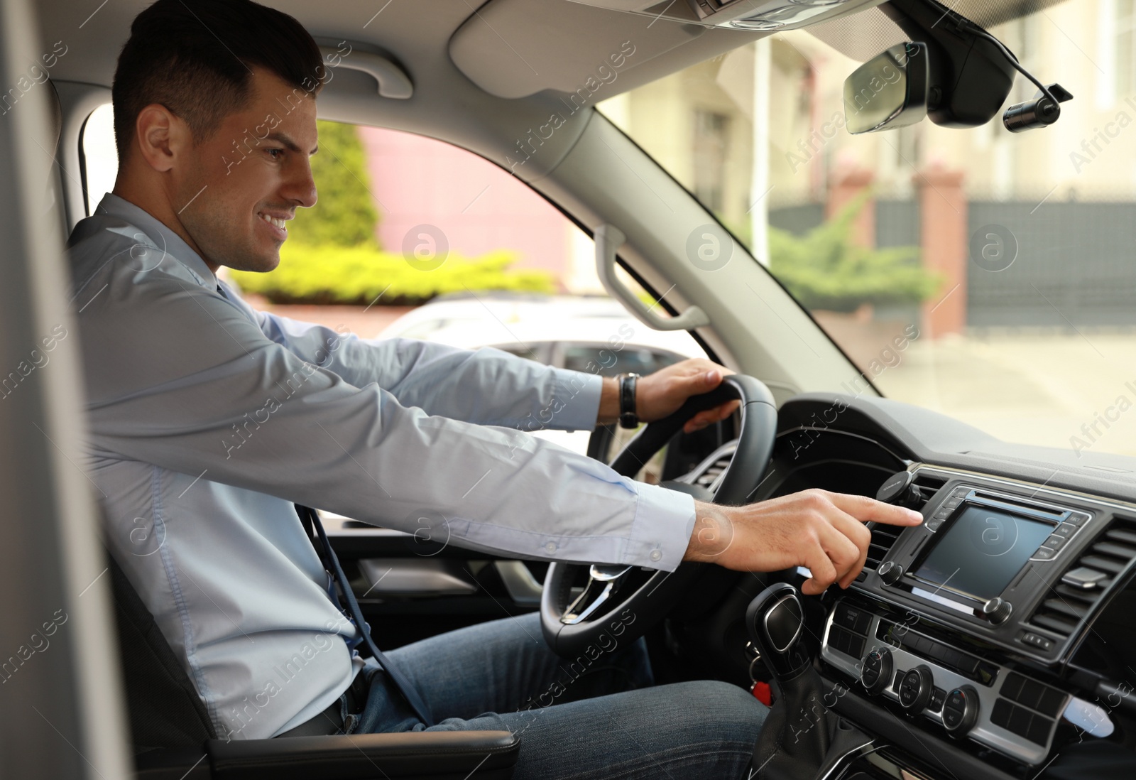 Photo of Man using navigation system while driving car