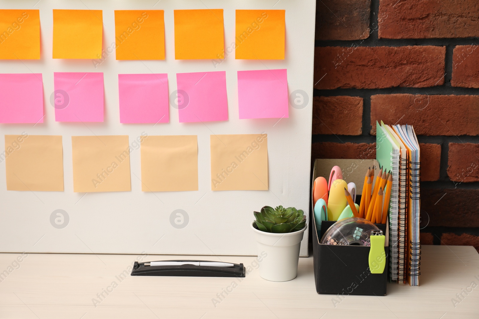 Photo of Business process planning and optimization. Workplace with colorful paper notes and other stationery on table