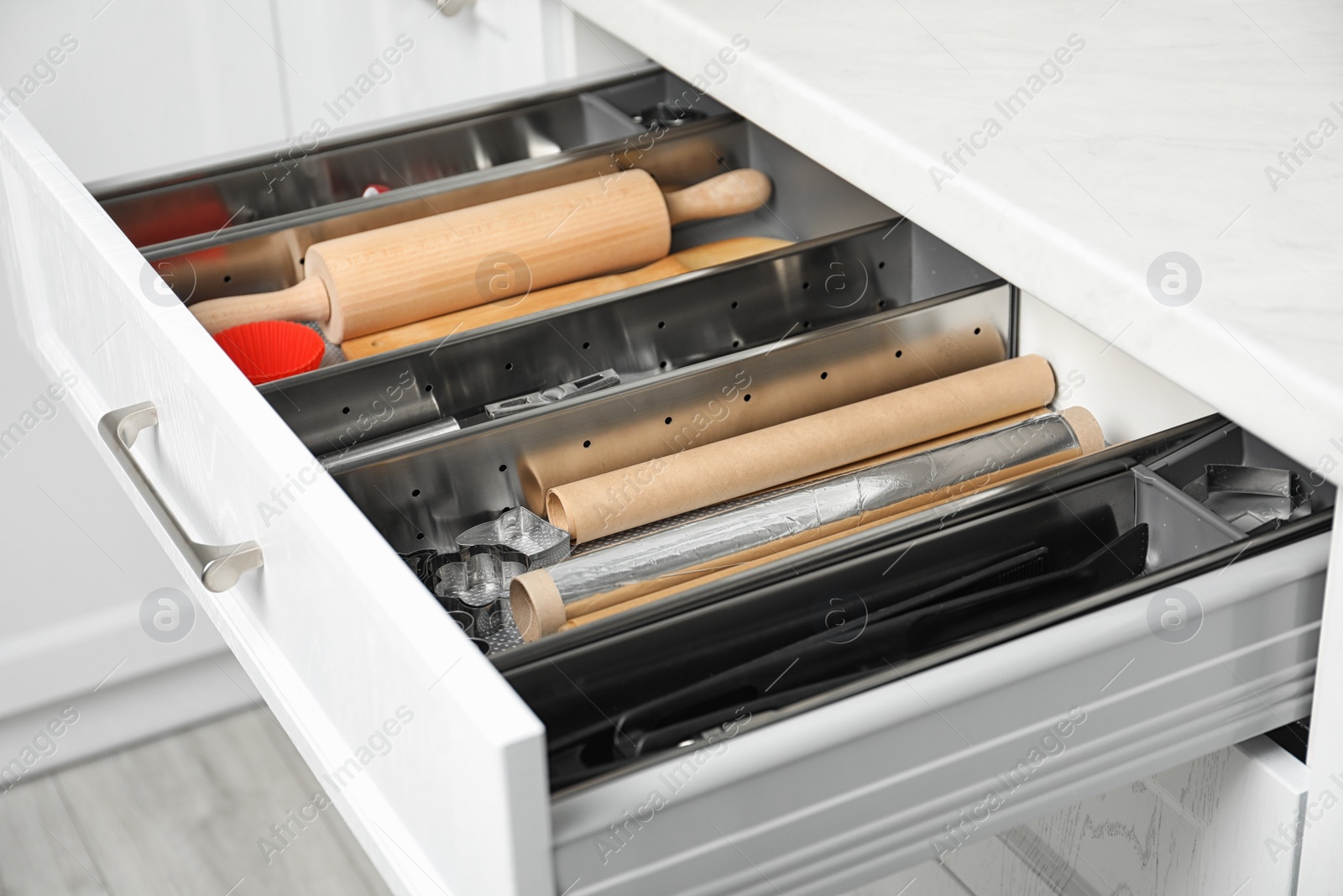 Photo of Different utensils in open desk drawer indoors