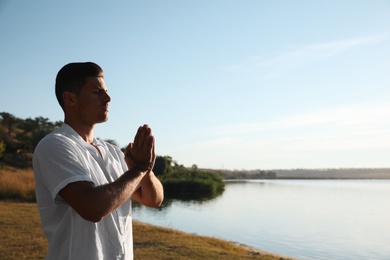 Photo of Man near river at sunset, space for text. Nature healing power