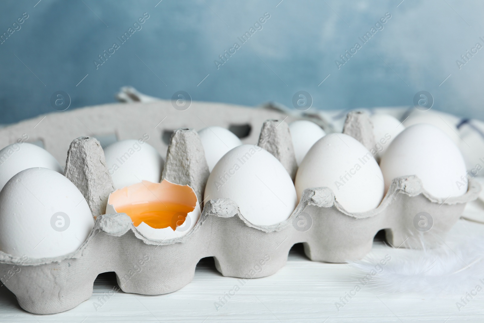 Photo of Fresh raw chicken eggs in box on white table