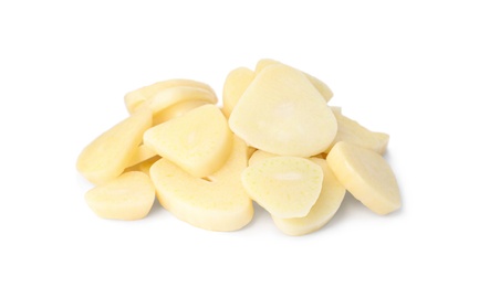 Photo of Pile of fresh sliced garlic cloves isolated on white. Organic food