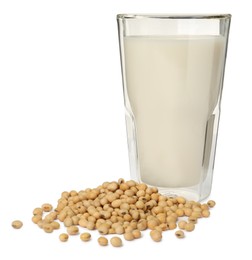 Photo of Glass of fresh soy milk and beans on white background