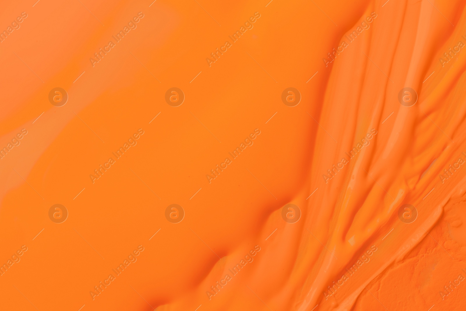 Photo of Bright orange paint as background, closeup view