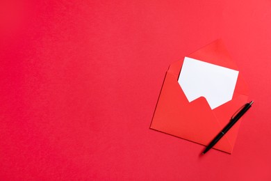 Photo of Blank sheet of paper, letter envelope and pen on red background, top view. Space for text