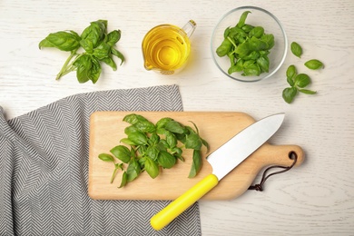 Photo of Flat lay composition with fresh basil leaves  on wooden background